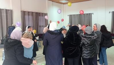 Palestinian women participate of a game with ropes in a psychosocial support session in Hebron.