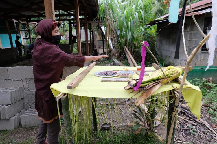 A Kagan woman conducts an indigenous ritual