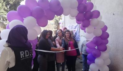 Opening of centre, group of women sorrounded by balloons
