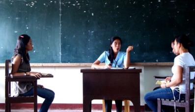 Three students discussing in a classroom